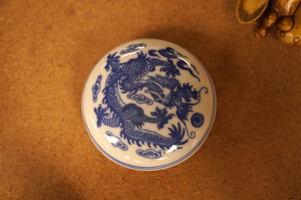 A collection of Chinese and Japanese items comprising snuff bottles, blue and white seal box and netsukes, largest 9cm high